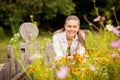 Attractive young woman standing near old wooden fence. Royalty Free Stock Photo