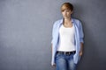 Attractive young woman standing by wall