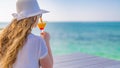 Attractive young woman in straw hat enjoy in sunny summer day with cocktail Royalty Free Stock Photo