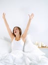 Attractive young woman stretching in bed after waking up Royalty Free Stock Photo