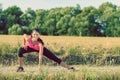 Attractive young woman stretching before jogging