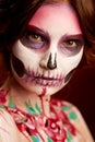 Attractive young woman with sugar skull halloween makeup