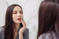 Attractive woman applying scrub on lips in bathroom Royalty Free Stock Photo