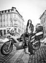 Attractive young woman in urban fashion shot near motorcycle. Beautiful fashionable young girl in black leather outfit Royalty Free Stock Photo