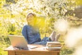 attractive young woman using laptop outside. Royalty Free Stock Photo