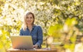 attractive young woman using laptop outside. Royalty Free Stock Photo