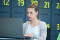 Attractive young woman using laptop while sitting at her desk. Young american businesswoman sitting in the office and working on Royalty Free Stock Photo