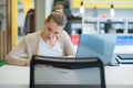 Attractive young woman using laptop while sitting at her desk. Young american businesswoman sitting in the office and working on Royalty Free Stock Photo