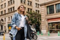 Attractive young woman walking in the city and look with smile away Royalty Free Stock Photo