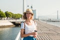 Attractive young woman walking in Lisbon near Tajus river at Park of the Nations Royalty Free Stock Photo