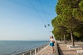 Attractive young woman walking in Lisbon near Tajus river at Park of the Nations Royalty Free Stock Photo