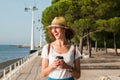 Attractive young woman walking in Lisbon near Tajus river at Park of the Nations Royalty Free Stock Photo