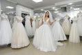 Attractive young woman wearing wedding dress in bridal shop Royalty Free Stock Photo