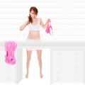 Attractive young woman wearing white bra and skirt, she is holding pink panties in her hand Royalty Free Stock Photo