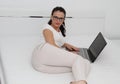 Attractive young woman working on her laptop at home Royalty Free Stock Photo