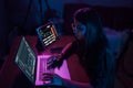 Attractive young woman working in home at night.