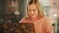 Attractive Young Woman Working on Laptop Computer while Sitting in Stylish Cozy Creative Office Royalty Free Stock Photo