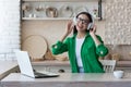 attractive young woman working with laptop and listening music at home. Royalty Free Stock Photo