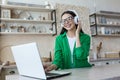 attractive young woman working with laptop and listening music at home. Royalty Free Stock Photo