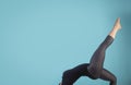 Attractive young woman working out, dancing on blue background. Athletic woman doing exercise. Strength and motivation