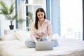 Young woman working remotely from home, typing on modern wireless laptop. Royalty Free Stock Photo