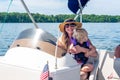 Young woman with young daughter on her lap driving a boat Royalty Free Stock Photo