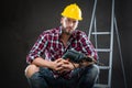 Attractive young workman with drill Royalty Free Stock Photo