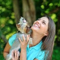 Attractive younggirl playing with her puppy outdoor