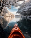 an attractively decorated kayak is floating past snow covered trees in a lake