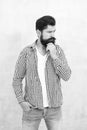 Attractiveness concept. Well groomed guy. Brutal handsome hipster man grey wall background. Bearded man trendy hipster