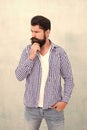 Attractiveness concept. Well groomed guy. Brutal handsome hipster man grey wall background. Bearded man trendy hipster