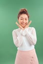 Attrative young Asian woman standing islated over green background Royalty Free Stock Photo