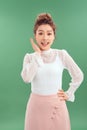 Attrative young Asian woman standing islated over green background Royalty Free Stock Photo