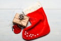 Attributes of christmas. Santa stocking with christmas gift box. Keep family traditions. Christmas decorative sock light