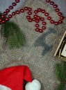 Attributes of christmasnew year in layout on gray background. Spruce branches next to beads and a deer. Royalty Free Stock Photo