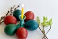 Easter eggs piled around a candle