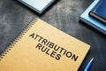 Attribution Rules near a book on the desk. Royalty Free Stock Photo