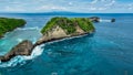 Atuh Beach is a Rustic, isolated cove beneath a sheer cliff face, with a sandy beach offshore rock formations Royalty Free Stock Photo