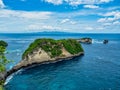 Atuh Beach is a Rustic, isolated cove beneath a sheer cliff face, with a sandy beach offshore rock formations Royalty Free Stock Photo