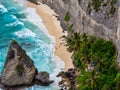 Atuh Beach is a Rustic, isolated cove beneath a sheer cliff face, with a sandy beach offshore rock formations Royalty Free Stock Photo