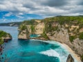 Atuh Beach is a Rustic, isolated cove beneath a sheer cliff face, with a sandy beach offshore rock formations Royalty Free Stock Photo