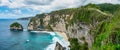 Atuh Beach is a Rustic, isolated cove beneath a sheer cliff face, with a sandy beach offshore rock formations