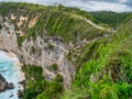 Atuh Beach is a Rustic, isolated cove beneath a sheer cliff face, with a sandy beach offshore rock formations Royalty Free Stock Photo