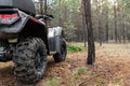 ATV awd quadbike motorcycle back pov view near tree in coniferous pine foggy forest with beautiful nature landscape