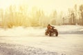 ATV driving on a snowy highway. Royalty Free Stock Photo