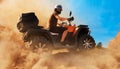 Atv in dust clouds, sand quarry on background Royalty Free Stock Photo