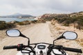 ATV quad bike parked on the coastal road along Aegean sea on Milos island, Greece