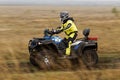 ATV racer on a dirt road through the fields. Royalty Free Stock Photo