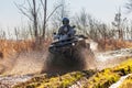 ATV racer drives through mud and water Royalty Free Stock Photo