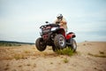 Atv racer in helmet riding in desert, action view Royalty Free Stock Photo